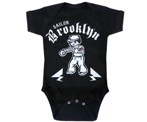 Black 100% cotton baby onesie featuring a retro tattoo-style sailor illustration with “Sailor Brooklyn Electric Tattoo Parlour” lettering and unisex fit with snap closures.